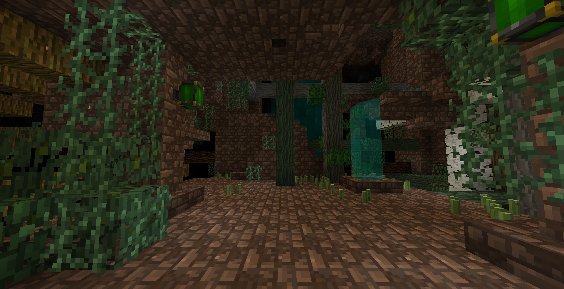 Dark area in Minecraft with old brown bricks and lush green plants growing in from the walls and ceiling, there is also a fountain.