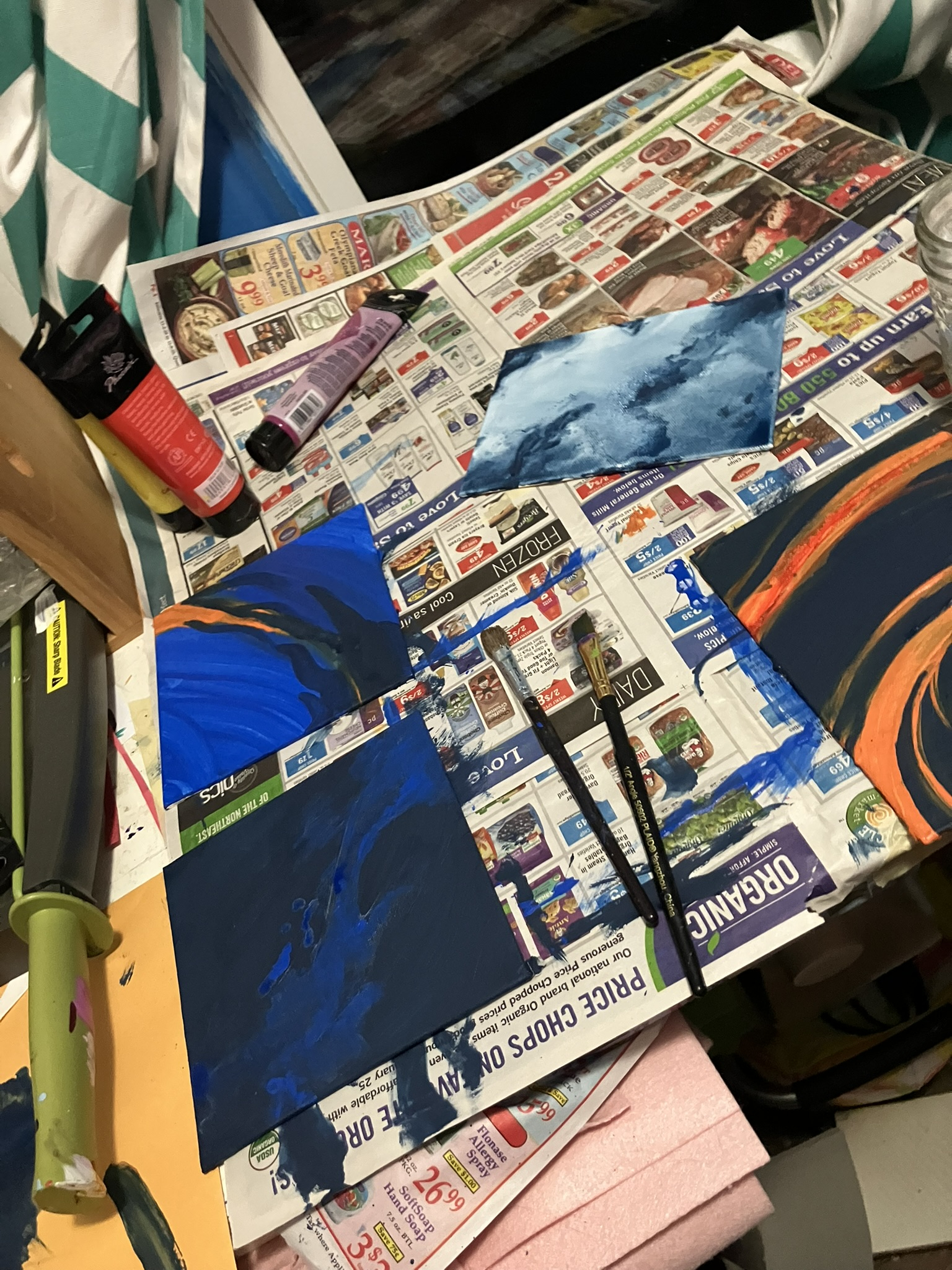 several smaller canvases also painted with blues but some oranges and different hues... not sure how i feel about most of these tho 